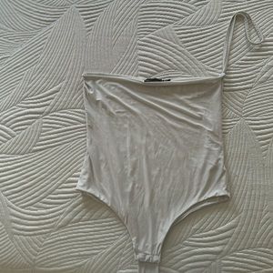 White body suit with one cross strap